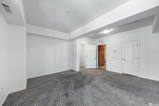 unfurnished bedroom with dark carpet and ensuite bath