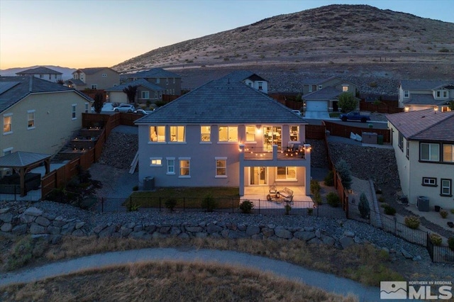 exterior space with a balcony, central AC unit, and a mountain view