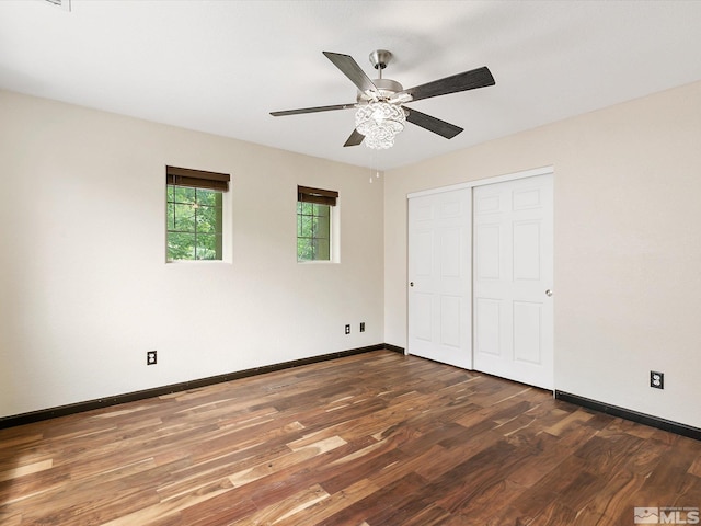 unfurnished bedroom featuring ceiling fan, a closet, and dark hardwood / wood-style floors