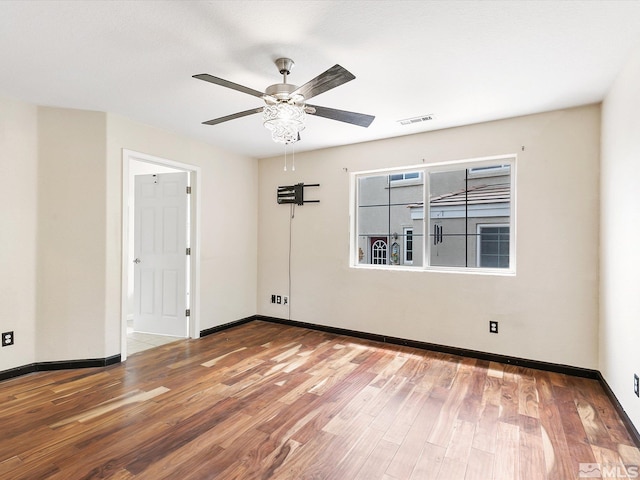 spare room with ceiling fan and wood-type flooring