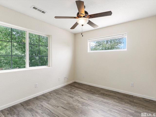 spare room with hardwood / wood-style floors and ceiling fan