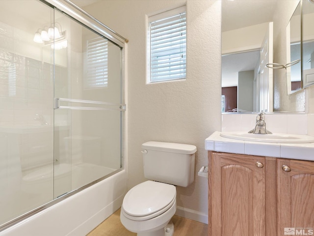 full bathroom with vanity, toilet, shower / bath combination with glass door, and an inviting chandelier