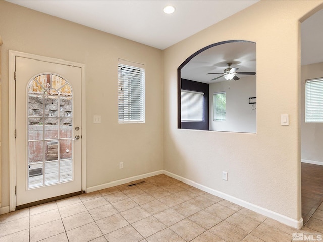 interior space with ceiling fan