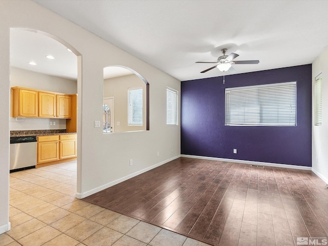 unfurnished room with ceiling fan and light hardwood / wood-style flooring