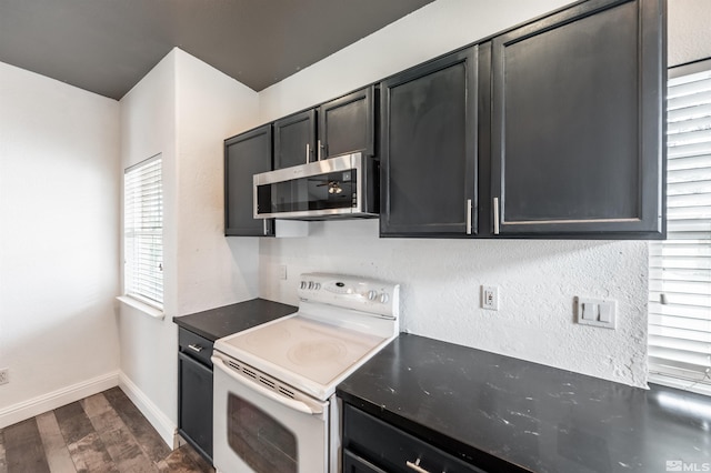 kitchen with dark wood-type flooring and white electric range oven