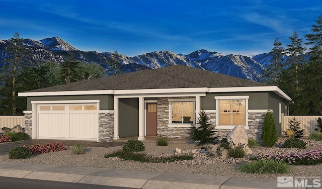 prairie-style house with a garage and a mountain view