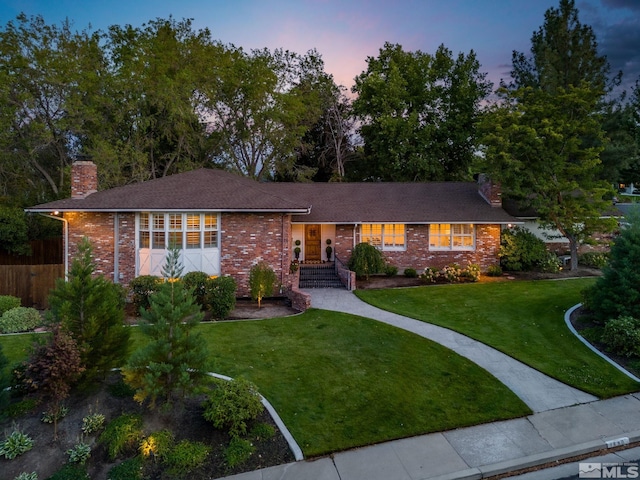 ranch-style house featuring a yard