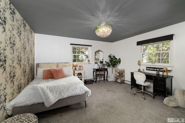 bedroom featuring carpet and an inviting chandelier