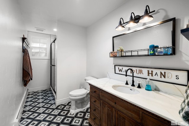 bathroom featuring vanity, toilet, and a shower with door