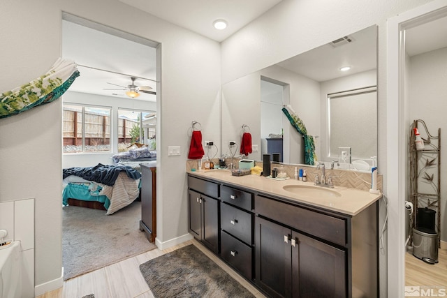 bathroom featuring ceiling fan and dual bowl vanity