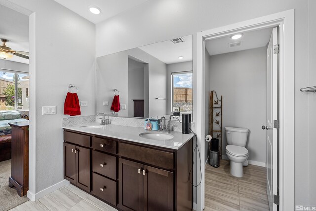 interior space featuring a tile fireplace, sink, and hardwood / wood-style flooring