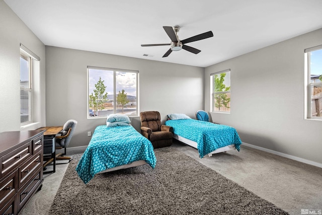 bedroom with carpet flooring, multiple windows, and ceiling fan