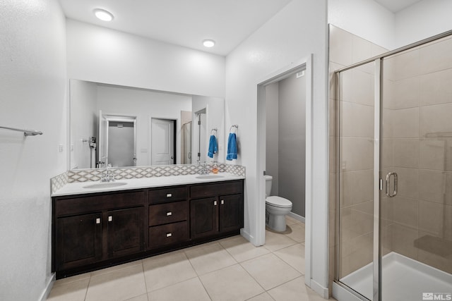 bathroom featuring vanity, tile patterned flooring, a shower with shower door, and toilet