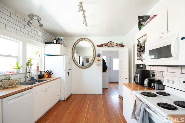 kitchen featuring sink, white cabinetry, white appliances, and light wood-type flooring