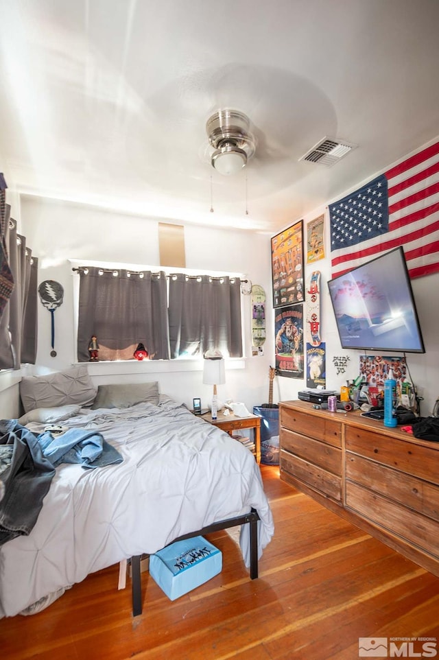 bedroom with ceiling fan and hardwood / wood-style floors