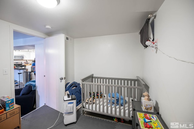 bedroom featuring a crib