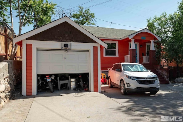 view of front of property with concrete driveway and a shingled roof