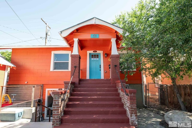 view of front of home with fence and a gate