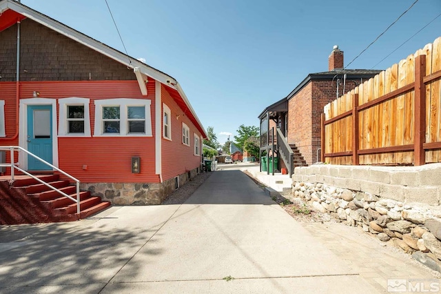 view of home's exterior featuring concrete driveway