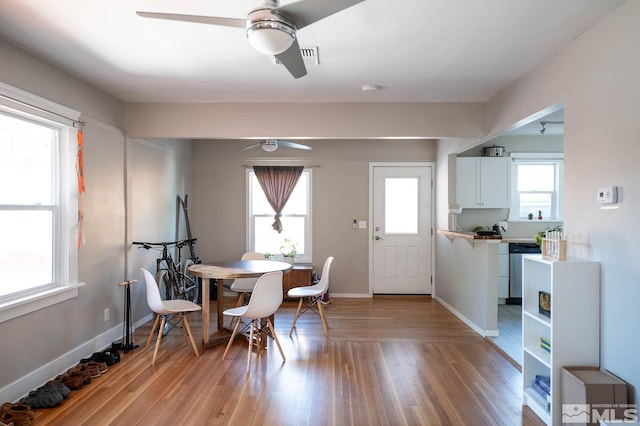 dining room with ceiling fan and light hardwood / wood-style flooring