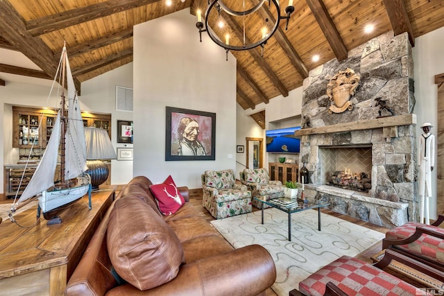 living room featuring hardwood / wood-style floors, high vaulted ceiling, a stone fireplace, beam ceiling, and wood ceiling