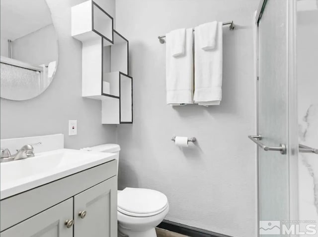 bathroom with vanity, toilet, and walk in shower