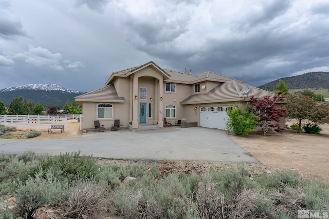 view of front of property featuring a mountain view and a garage