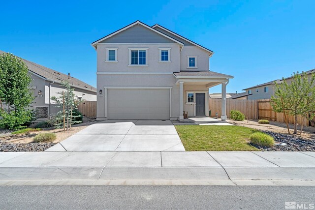 view of front of property featuring a front yard and a garage