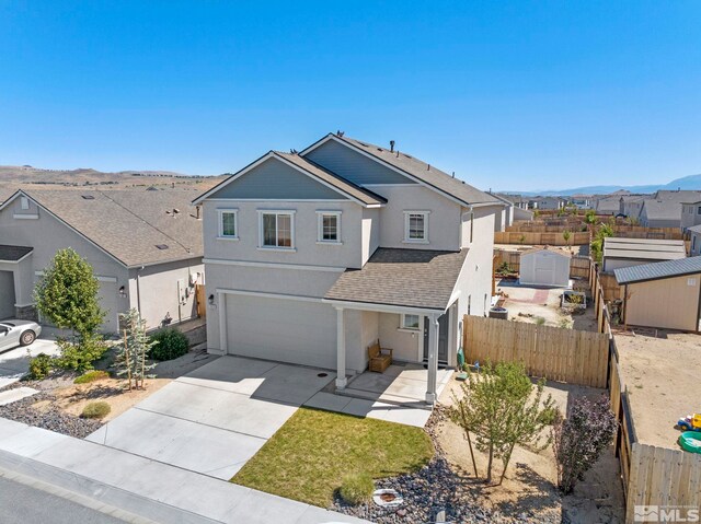 view of front of property featuring a garage and a mountain view