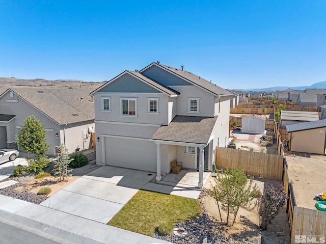 view of front of property featuring a mountain view and a garage