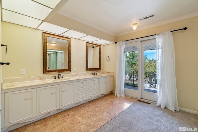 bathroom with tile patterned flooring, vanity, and crown molding