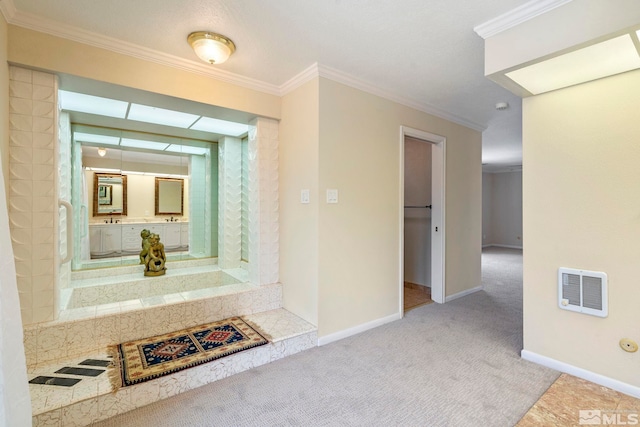 corridor with sink, ornamental molding, and light carpet