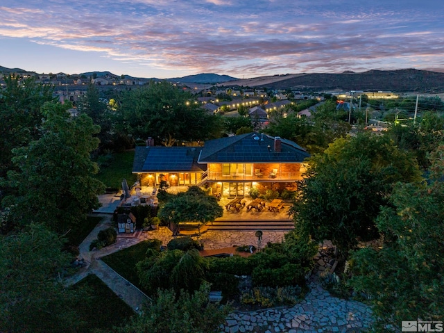 aerial view at dusk featuring a mountain view