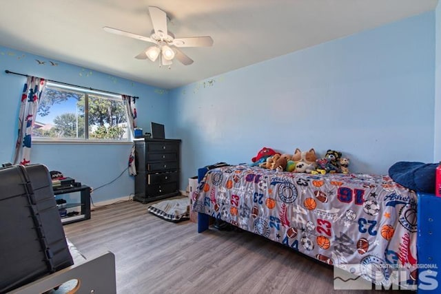 bedroom featuring hardwood / wood-style flooring and ceiling fan