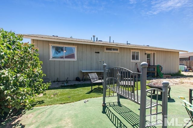 rear view of property with a lawn