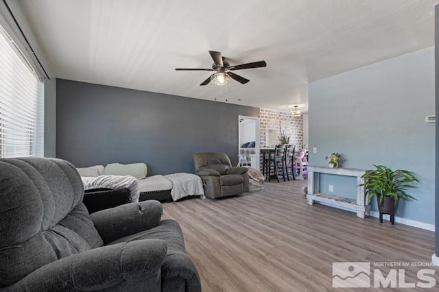 living room with ceiling fan and hardwood / wood-style flooring