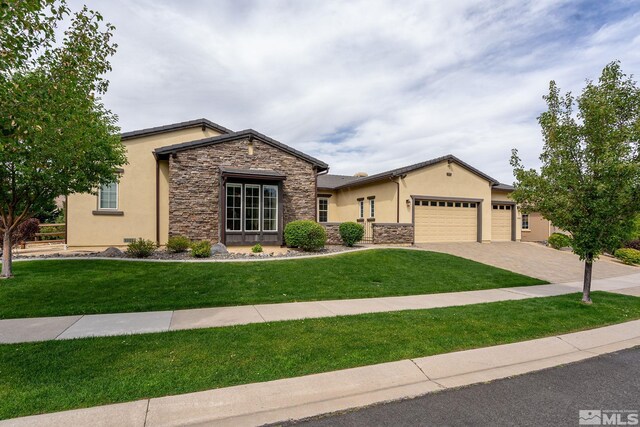 view of front of home with a garage and a front lawn