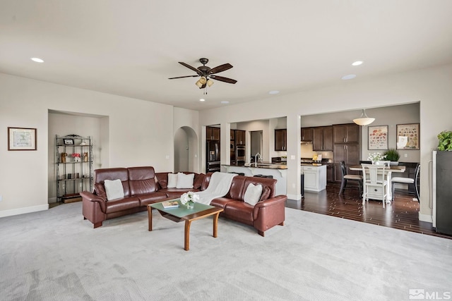 living room with sink, ceiling fan, and hardwood / wood-style floors