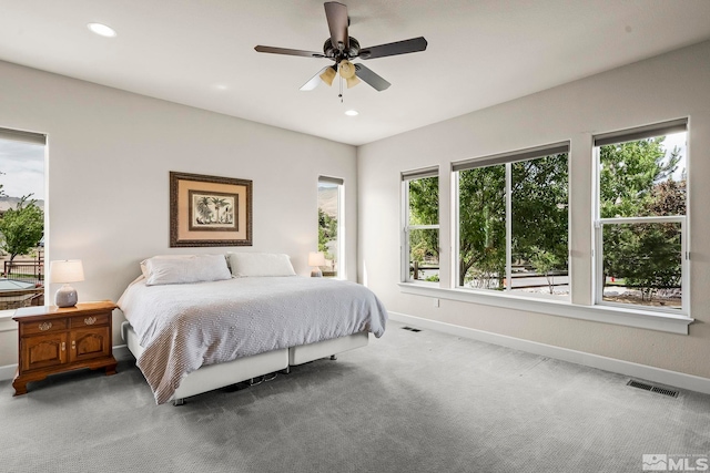 carpeted bedroom featuring a ceiling fan, recessed lighting, visible vents, and baseboards