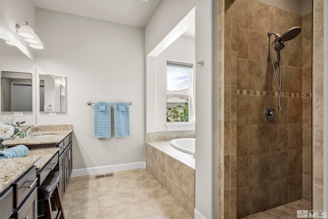 full bath featuring baseboards, visible vents, a tile shower, and vanity