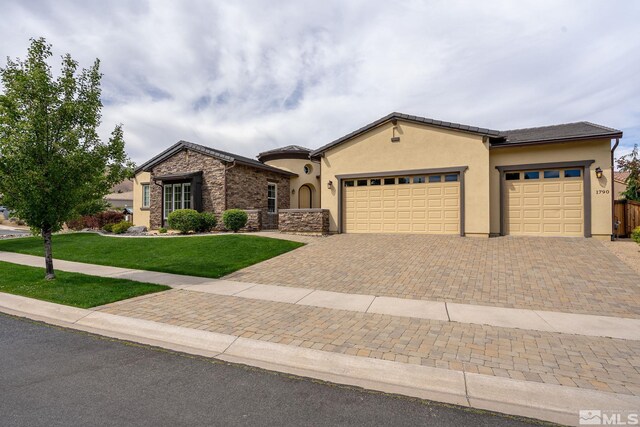 view of front of house with a garage and a front yard