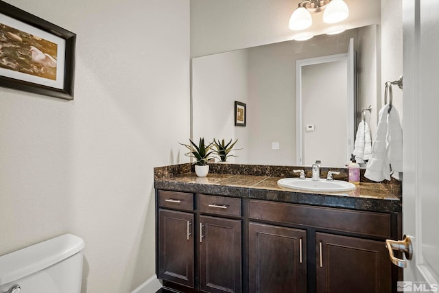 half bath with vanity and toilet