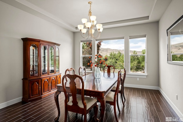 dining area with an inviting chandelier, a wealth of natural light, and dark hardwood / wood-style floors