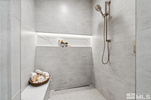 bathroom with tiled shower