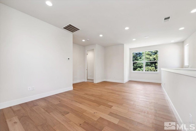 empty room with light hardwood / wood-style flooring