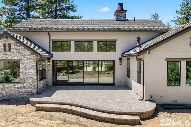 rear view of property featuring a patio area