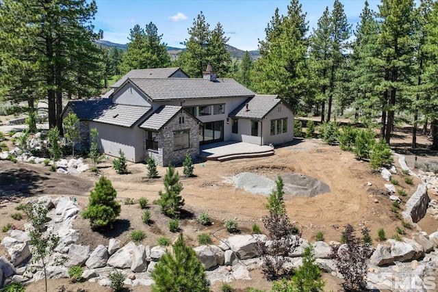 back of property with a mountain view