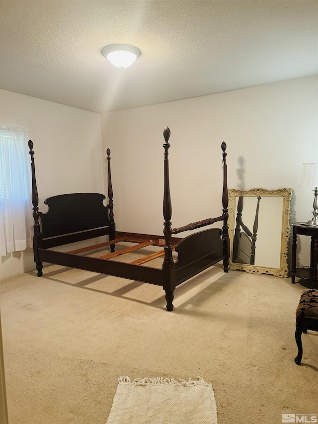 carpeted bedroom with a textured ceiling