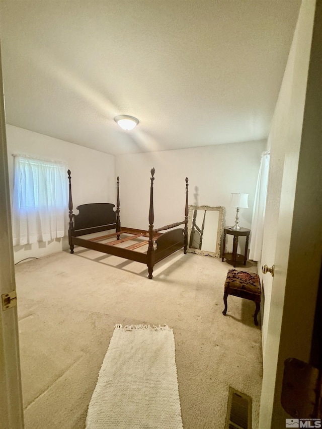 carpeted bedroom with a textured ceiling