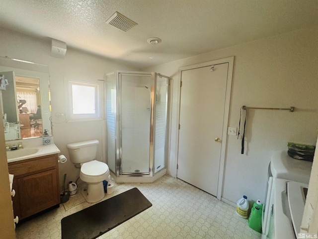 bathroom with a textured ceiling, vanity, toilet, and an enclosed shower